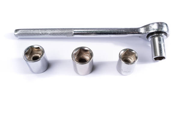 istock Closeup shot of a socket wrench and sockets on a white background 1464954551