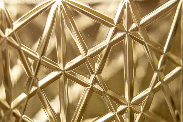 istock Closeup of the triangle-shaped patterns on the golden plastic surface 1464955307