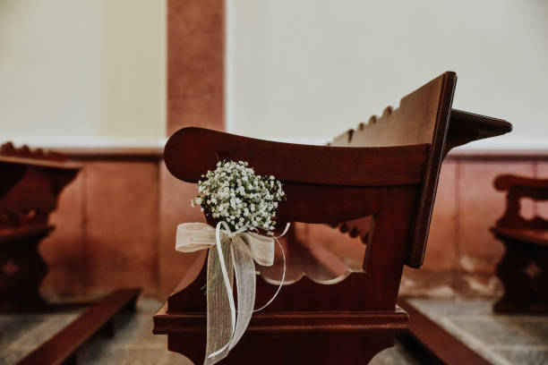 istock Wedding decor on a bench in a church 1464955454