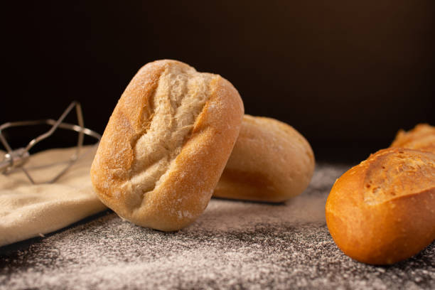 istock Homemade freshly baked bread on a kitchen table 1464955928