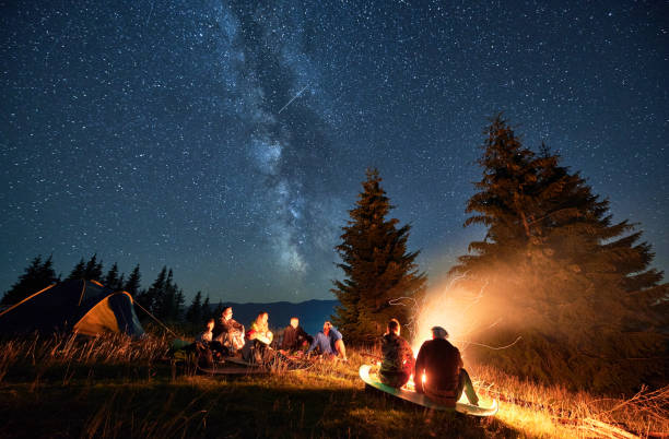 istock Night camping in mountains under starry sky with Milky way. 1464956198