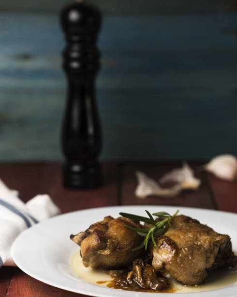 istock Closeup of fried chicken with sauce and herb on a plate 1464956900