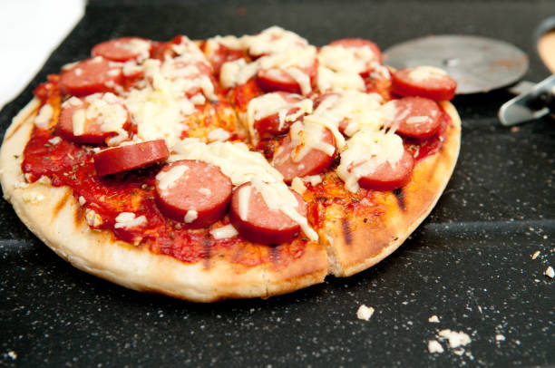 nahaufnahme einer köstlichen mini-pizza mit würstchen - saussage stock-fotos und bilder