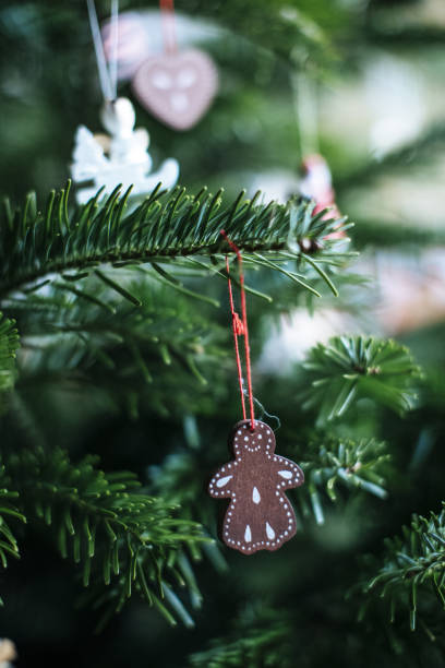 istock Selective focus of a small ornate gingerbread hanged on the Christmas tree 1464957398