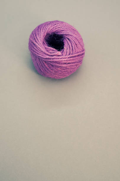 istock Vertical shot of a purple thread yarn isolated on a grey background 1464958412
