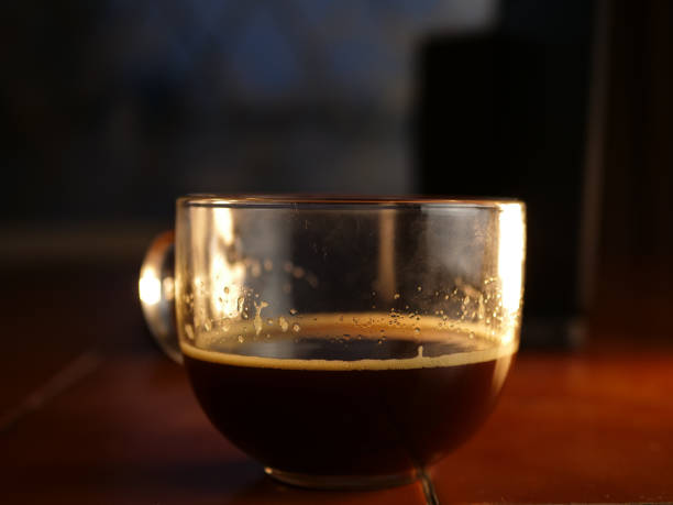 istock Mug of fresh dark coffee on dark background 1464958977