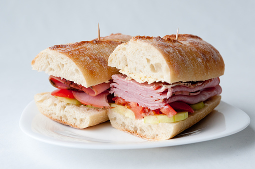 rosemary ham sandwich on baguette with fresh tomato and cucumber