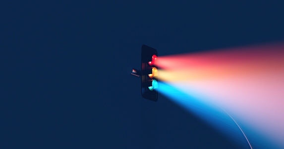 Traffic light with a three-color light beam on a blue background for an advertising image with a copy space