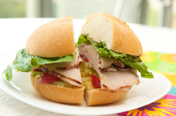 istock Halved homemade burger with ham and vegetables on a plate 1464959914