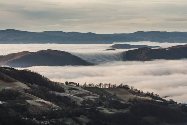 istock High angle view of mountaintops surrounded by clouds 1464960385
