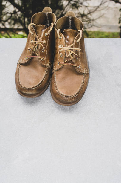 istock Vertical shot of comfortable brown shoes on a gray surface 1464960884