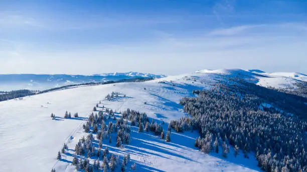 Beautiful mountain range in winter with powder snow and blue sky
