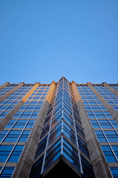 istock Low angle shot of a modern office building under the sunlight and a blue sky 1464967769