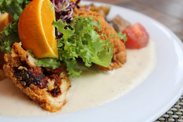 istock Plate of fried chicken with lemon and fresh vegetables 1464968276