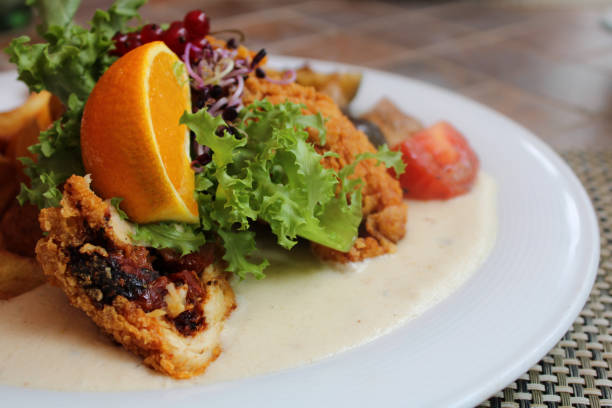 istock Plate of fried chicken with lemon and fresh vegetables 1464968278