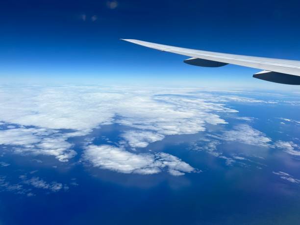 istock Aircraft wing looking over ocean 1464969459