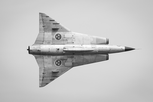 A swedish Saab S-35 Draken cold war jet performing a fly pass at high speed