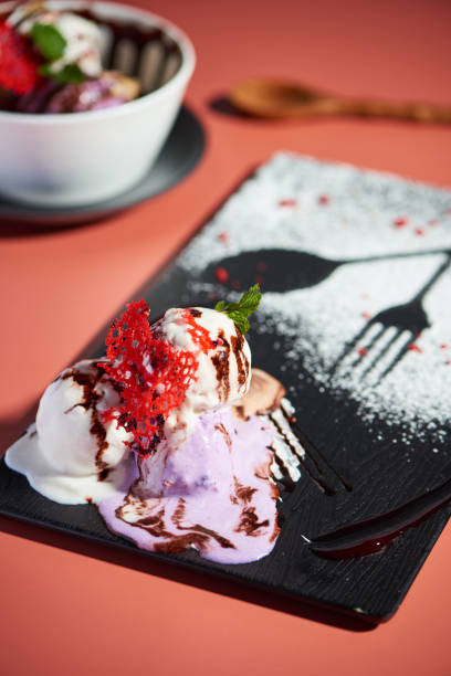 Vertical shot of ice cream served on a decorated black plate