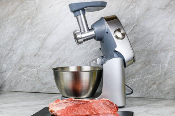 istock Modern food processor with meat grinder and peace of pork meat on a kitchen table 1464972696