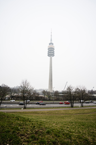 A vertical shot of the TV tower in Munich against of cloudy sky