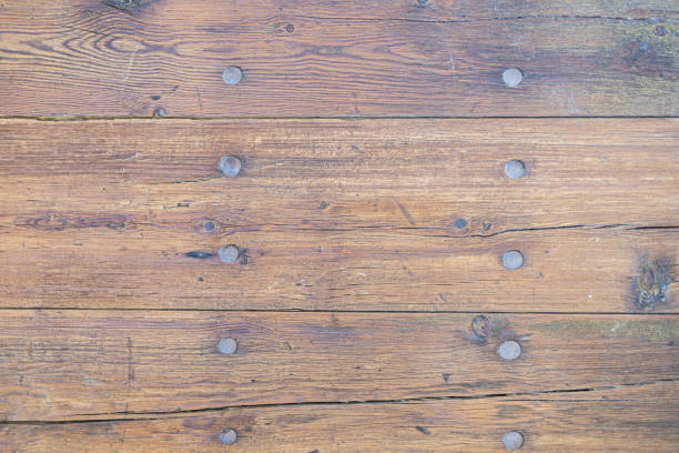 A woody wallpaper - walnut wood boards with nails through them