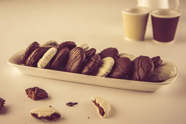 A plate of homemade cookies covered with brown and whitechocolate