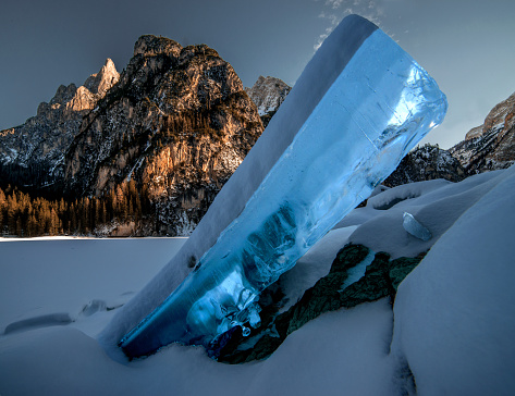 An icicle in the frozen Pragser Wildsee lake in South Tyrol, Italy in winter