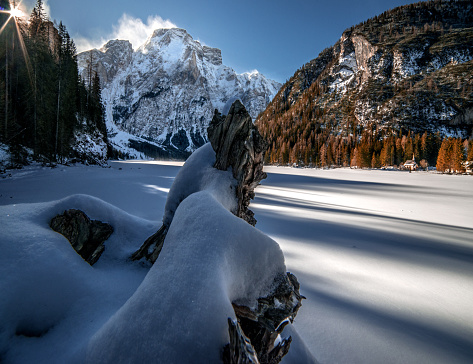 The frozen Pragser Wildsee lake and valley covered with snow in South Tyrol, Italy