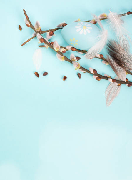 istock Easter eggs with willow branches and bird feathers, holiday greeting card, spring season background 1464978458