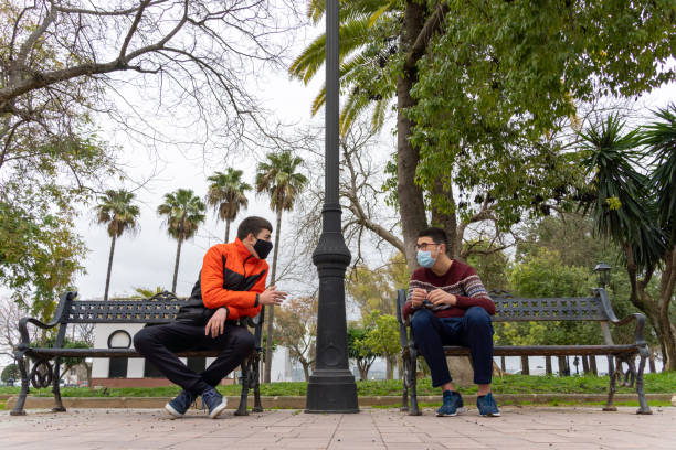 istock Young Friends Talking in the Park 1464978603