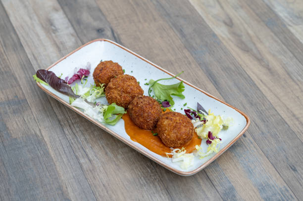 istock Dish with delicious cheese balls and salad 1464979102