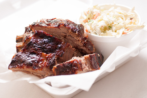 pork ribs take away meal with cole slaw and sauce, food truck style