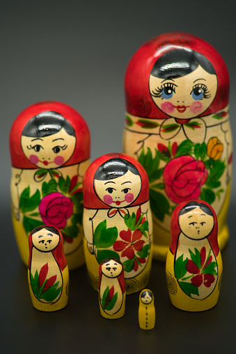 a set of 7 matrioshka dolls isolated on dark background