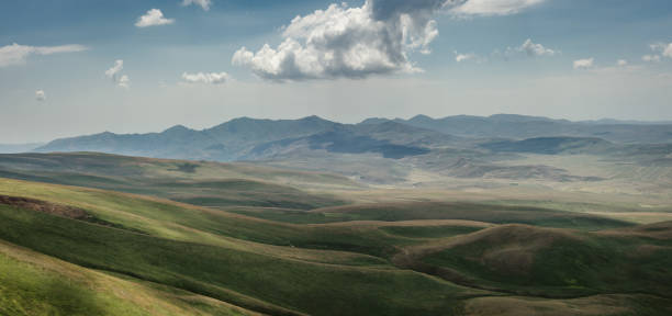 istock Panoramic view of rocky hills covered in greenery at daytime 1464981279