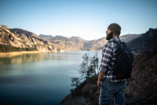 Hiking alone. Tourist exploring lake in mountains