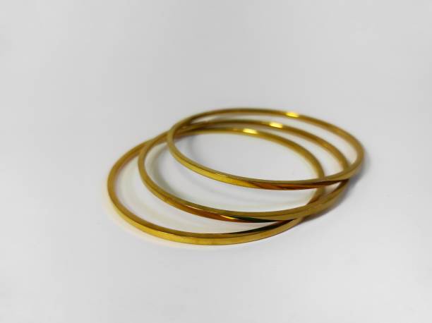 istock Three golden bracelets . Gold jewelry 1464993779