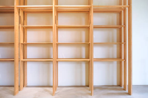 Wide angle view of simple empty wooden shelf rack, for mock up display purpose. Shelving unit for products merchandise branding display; point-of-sale in natural lighting.