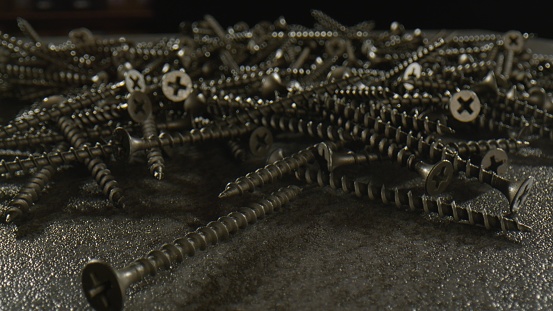 Big stack of long black screws - close up