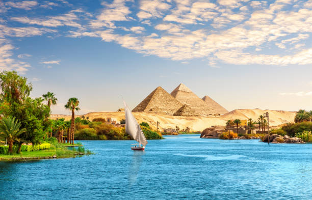 Beautiful Nile scenery  with sailboat in the Nile on the way to pyramids, Aswan, Egypt stock photo