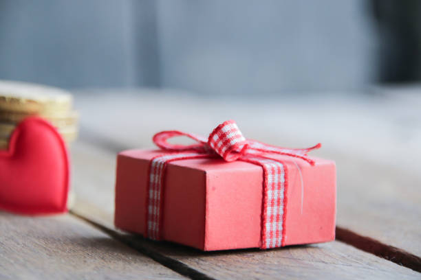 istock Gift with a ribbon on a beautiful wooden background. 1465001157