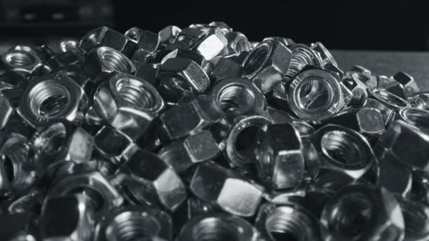 istock Huge pile of silver nuts fasteners on black tabel 1465002023