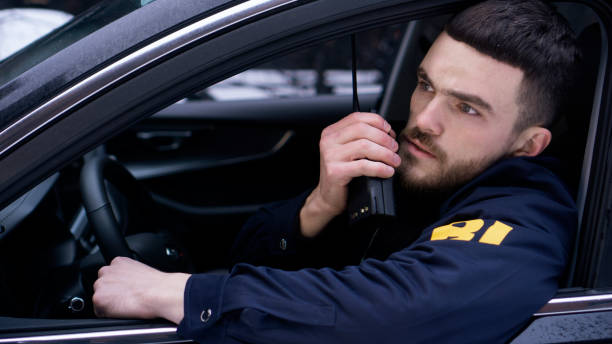istock Attractive FBI agent with a walkie-talkie during surveillance 1465005470