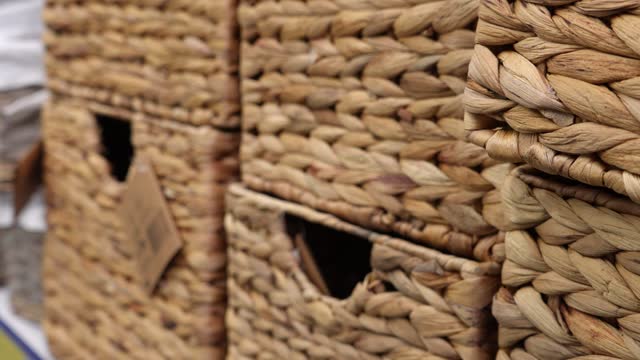 Empty rectangular wicker wooden storage baskets in a shop window.