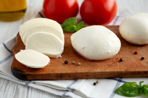 istock Homemade Mozzarella Cheese with Tomato, Basil and Olive Oil, side view. Close-up. 1465018237