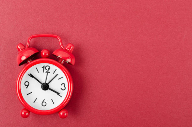 istock The Red alarm clock on red colour background. 1465019462