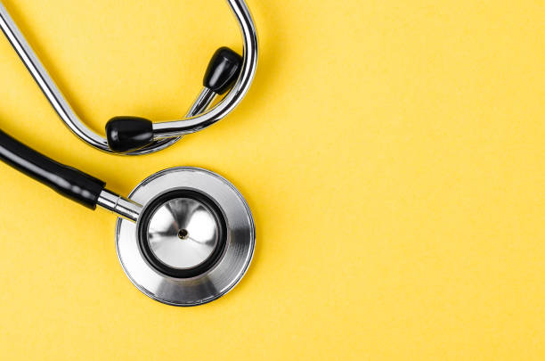 Close up Stethoscope on yellow background with empty space for your text. stock photo
