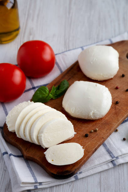 istock Homemade Mozzarella Cheese with Tomato, Basil and Olive Oil, side view. 1465022903