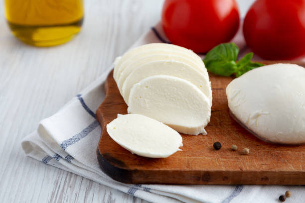istock Homemade Mozzarella Cheese with Tomato, Basil and Olive Oil, low angle view. Close-up. 1465023092