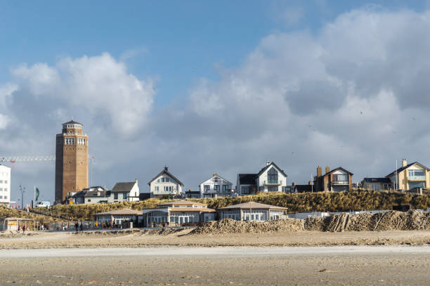 Beach houses and the lighthouse at Zandvoort stock photo