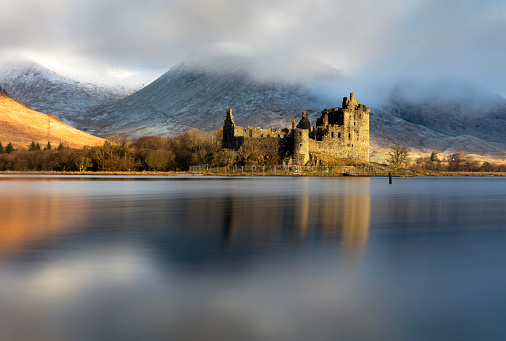 Kilchurn castle and Loch Awe in the Scottish Highlands in dramatic early morning light